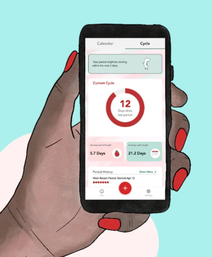 A woman's hand holding a phone with a period tracker app
