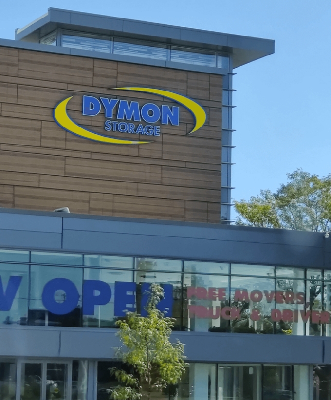 The outside of a building with a sign reading Dymon Storage