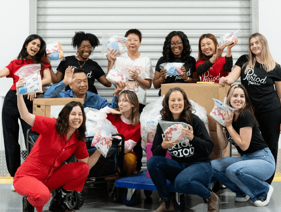 Volunteers posing and smiling in front of a camera
