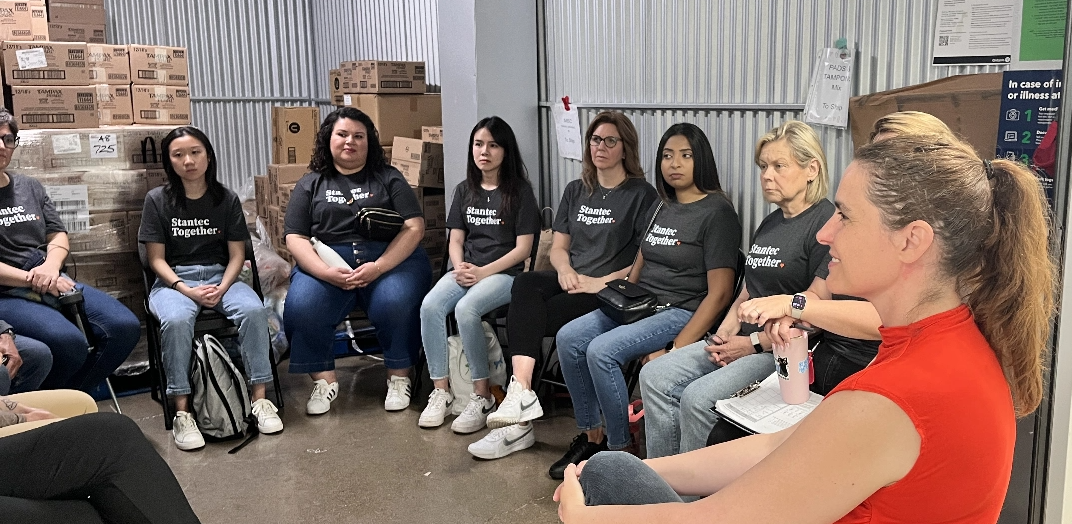 A group of Stantec employees sitting in a circle