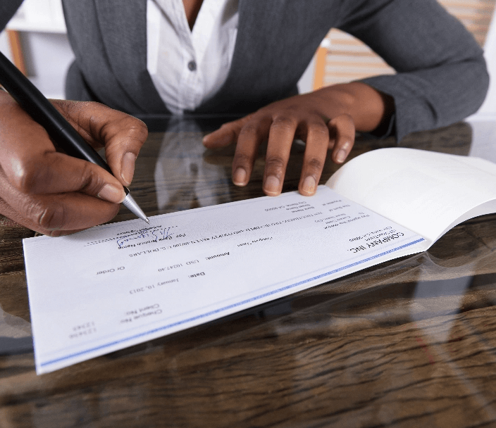 A person writing a cheque