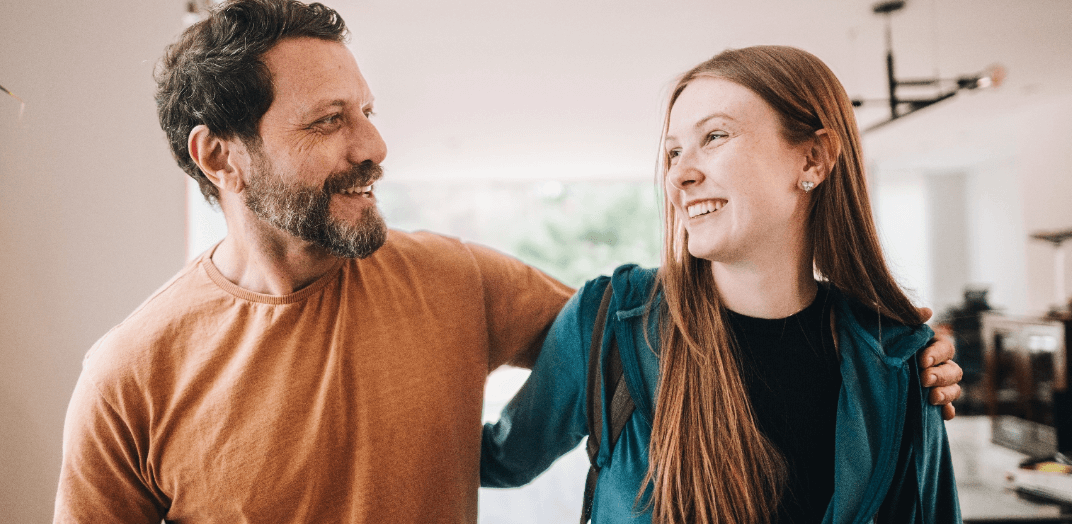 A man and a woman smiling to each other
