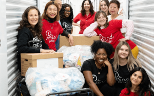 Volunteers posing and smiling in front of a camera