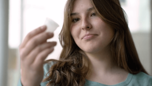 A woman holding a period product