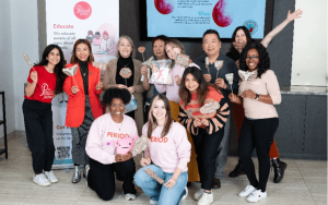 Volunteers posing and smiling in front of a camera